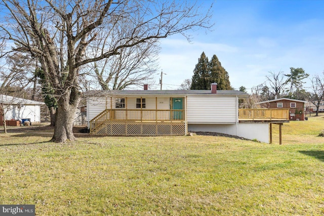 back of property featuring a yard and a wooden deck