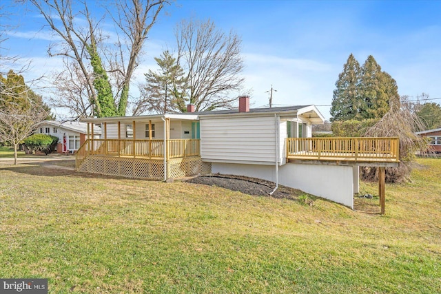 back of property featuring a yard and a deck