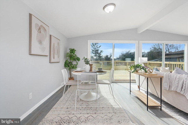 sunroom / solarium with lofted ceiling with beams