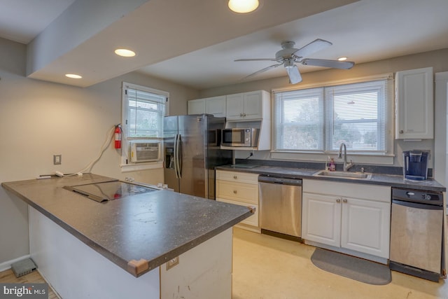 kitchen featuring sink, ceiling fan, white cabinetry, kitchen peninsula, and stainless steel appliances