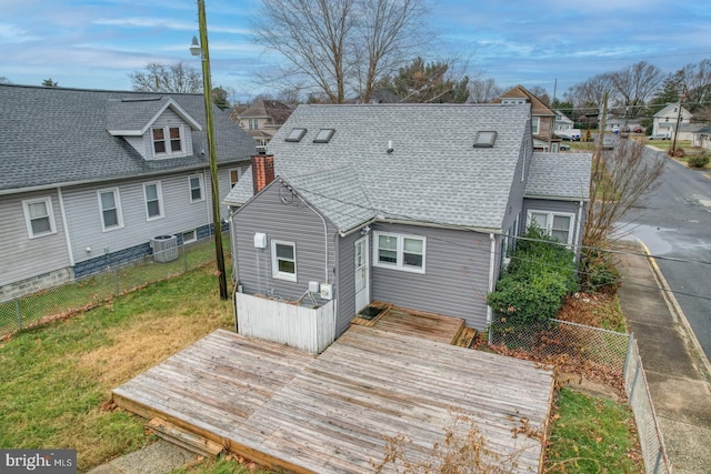 rear view of house with central air condition unit and a wooden deck