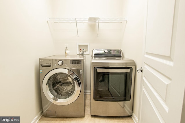 laundry area with washing machine and clothes dryer