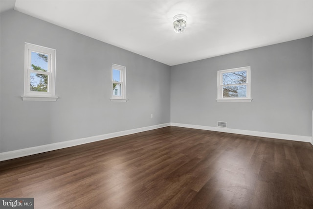 empty room featuring dark hardwood / wood-style flooring