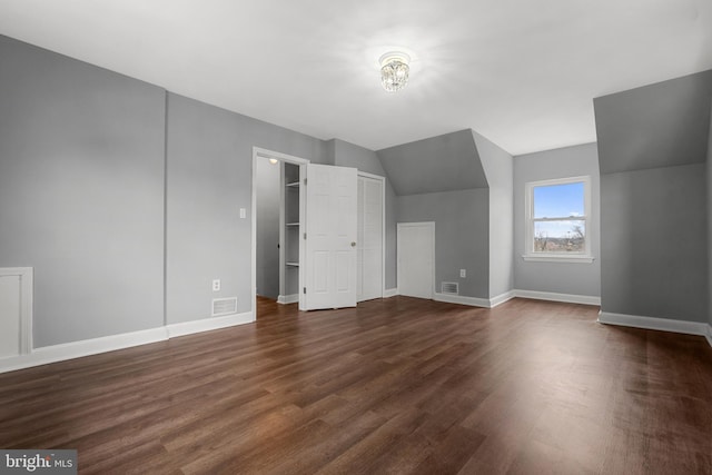 bonus room featuring dark hardwood / wood-style flooring and vaulted ceiling