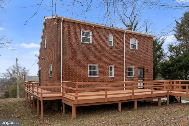 back of house with a wooden deck