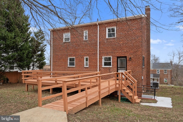 rear view of property featuring central AC unit and a wooden deck