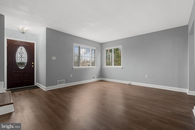 foyer featuring dark hardwood / wood-style floors and a notable chandelier