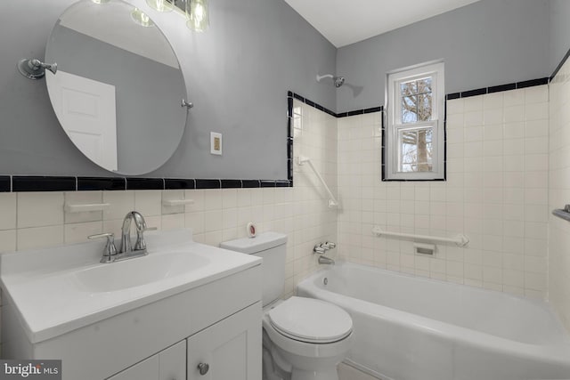 full bathroom featuring tile walls, vanity, tiled shower / bath combo, and toilet