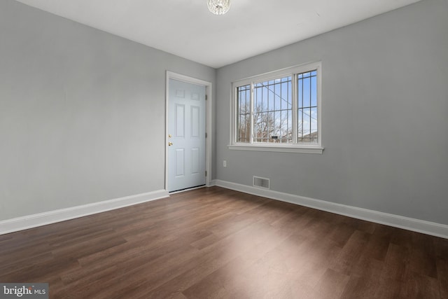 spare room with dark hardwood / wood-style flooring