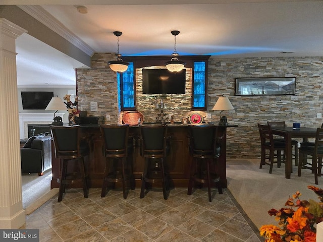 bar featuring crown molding and hanging light fixtures