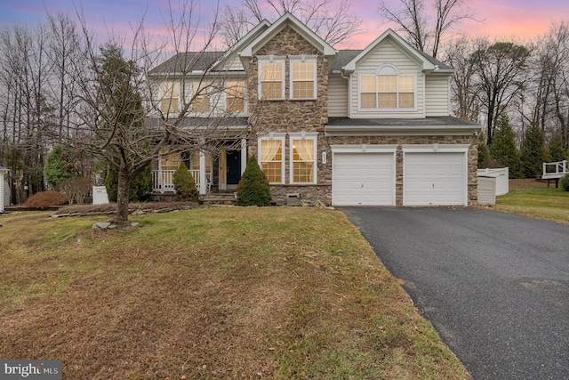 view of front of property with a lawn and a garage