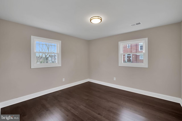 empty room with dark hardwood / wood-style floors