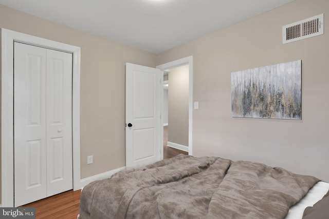 bedroom with a closet and wood-type flooring