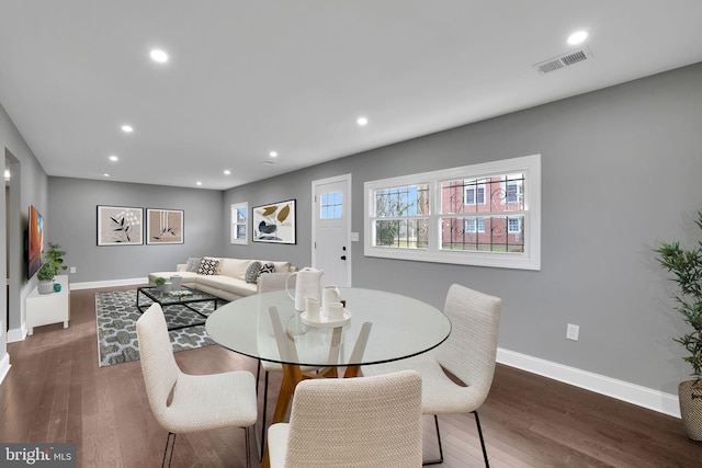 dining space with dark hardwood / wood-style flooring