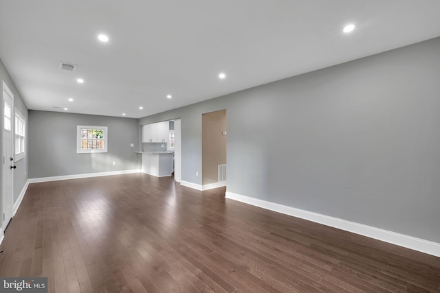 unfurnished living room featuring dark hardwood / wood-style floors