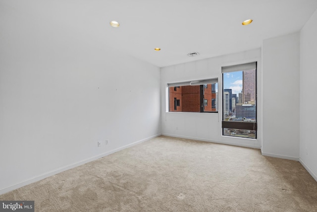 unfurnished room with light carpet