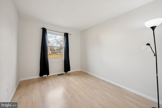 unfurnished room with light hardwood / wood-style flooring