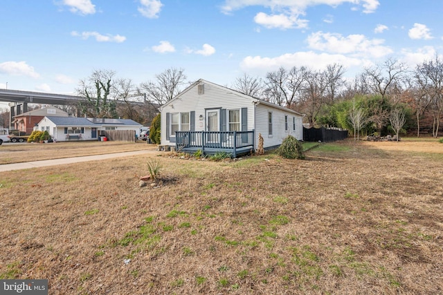 view of side of home featuring a deck and a lawn