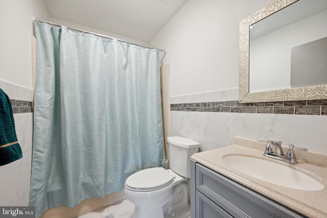 full bathroom featuring vanity, toilet, tile walls, and shower / tub combo