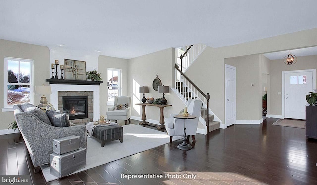 living room featuring a healthy amount of sunlight and dark hardwood / wood-style flooring