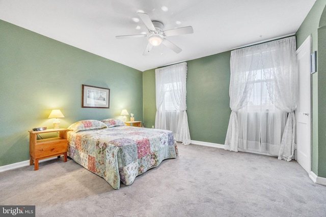 bedroom with ceiling fan and light colored carpet