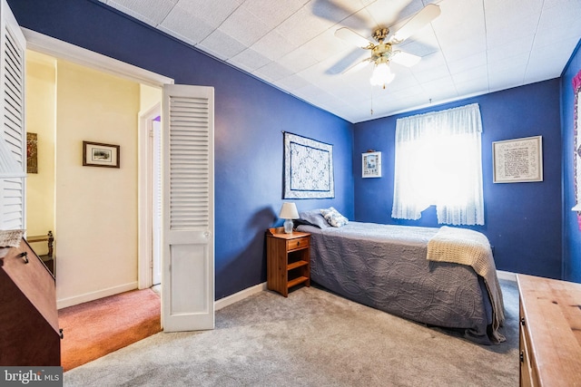 bedroom with ceiling fan and light carpet