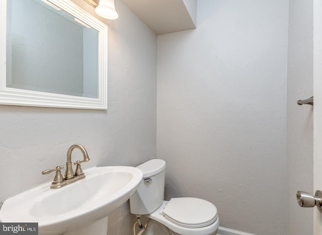 bathroom with toilet and sink