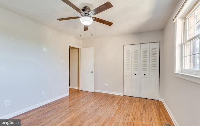 unfurnished bedroom featuring ceiling fan, light wood-type flooring, and a closet