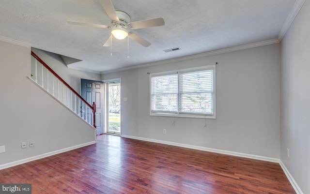 spare room featuring hardwood / wood-style flooring, ceiling fan, crown molding, and a textured ceiling