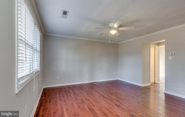 spare room featuring a textured ceiling, dark hardwood / wood-style flooring, ceiling fan, and ornamental molding