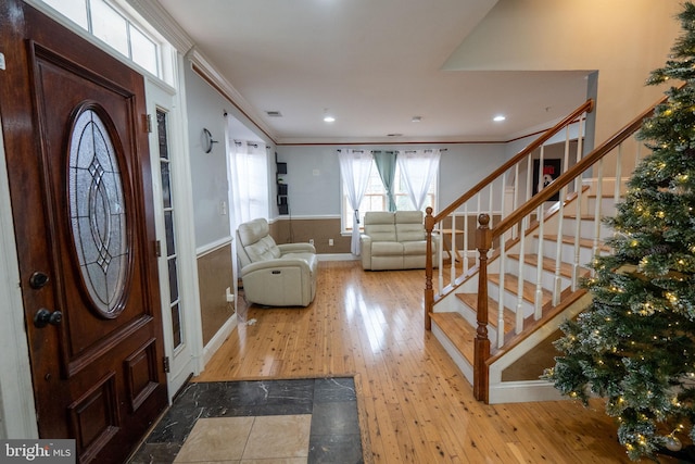 foyer featuring light hardwood / wood-style floors and crown molding