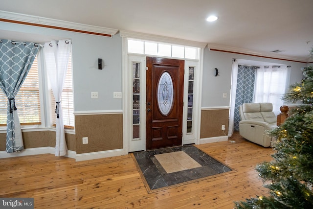 entrance foyer featuring hardwood / wood-style floors and ornamental molding