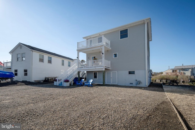 back of property with a balcony