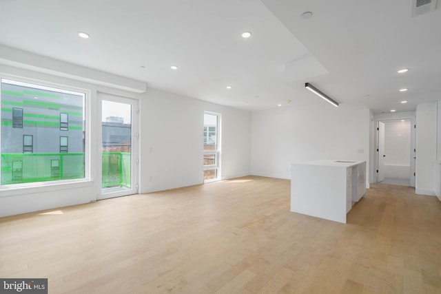 unfurnished living room with light hardwood / wood-style flooring