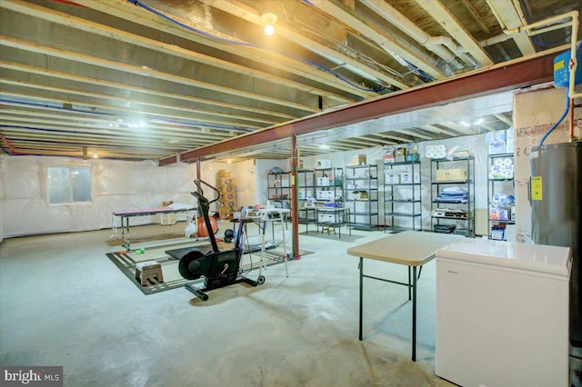 basement with water heater and fridge