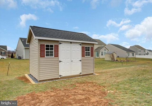 view of outdoor structure featuring a lawn