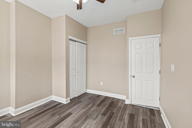 5738 Tulip St, Philadelphia, PA 19135 - unfurnished bedroom featuring dark wood-style flooring, a closet, and ceiling fan