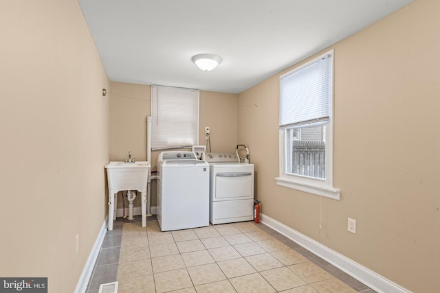 5738 Tulip St, Philadelphia, PA 19135 - washroom featuring washing machine and clothes dryer and light tile patterned floors