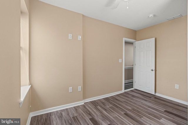 5738 Tulip St, Philadelphia, PA 19135 - spare room with wood finished floors, a smoke detector, and a ceiling fan