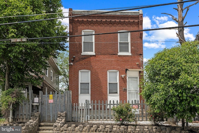 5738 Tulip St, Philadelphia, PA 19135 - view of front of house with brick siding, a fenced front yard, and a gate