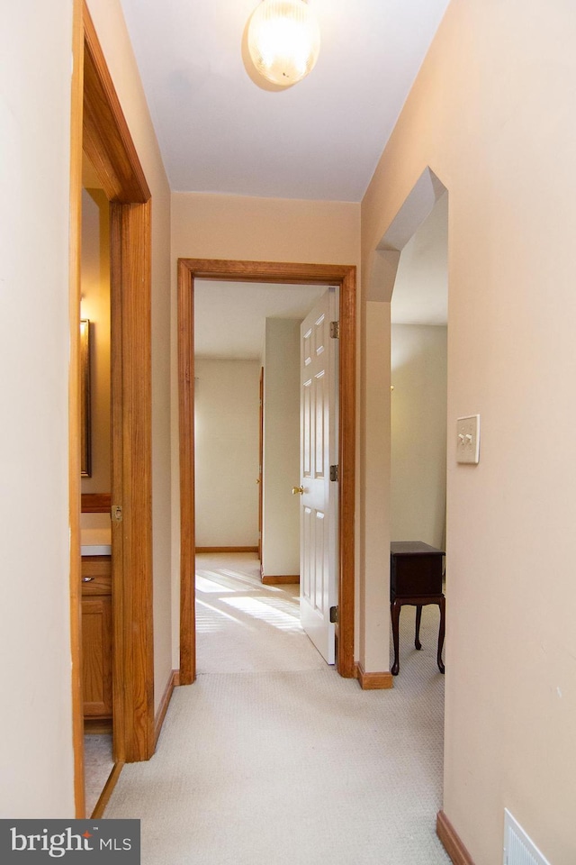 hall featuring light colored carpet