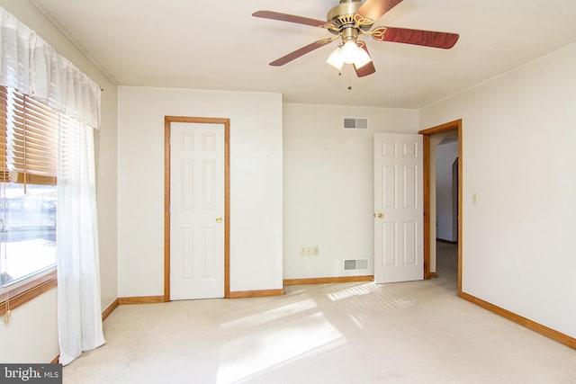 unfurnished bedroom featuring carpet and ceiling fan