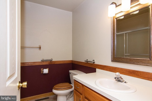 bathroom featuring vanity and toilet