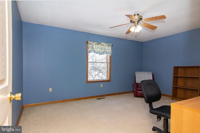 unfurnished office with ceiling fan and light carpet