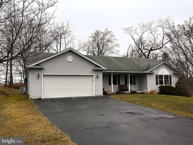 ranch-style home with a front lawn, cooling unit, and a garage