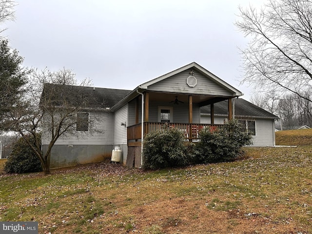 view of front of house with a front yard, a porch, and ceiling fan