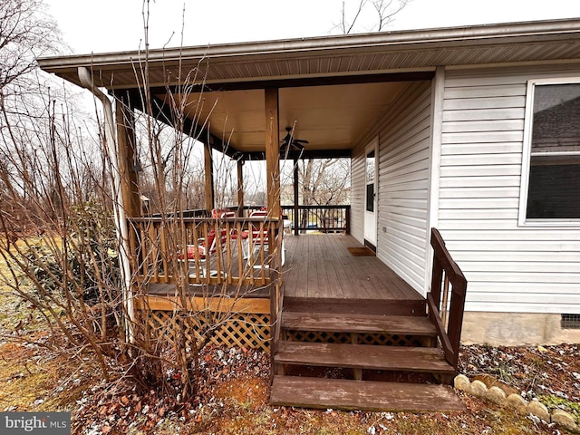 deck featuring covered porch and ceiling fan