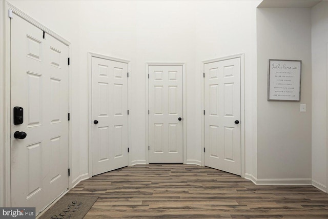 corridor with dark hardwood / wood-style flooring