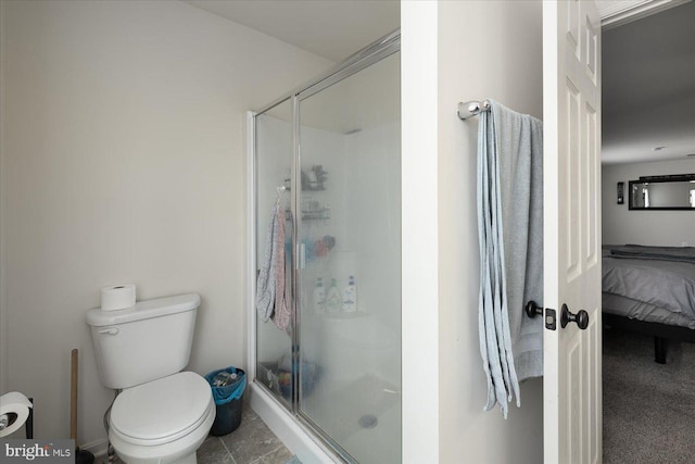 bathroom with tile patterned floors, an enclosed shower, and toilet