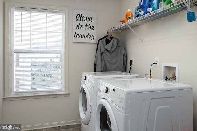 washroom with washer and dryer, tile patterned floors, and a wealth of natural light